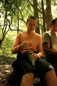 It's summer, but it's still cool in the forest.  We sit down for a snack and a brew.  Laura gets the grind on.